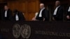 Presiding Judge Nawaf Salam (center) ask the parties to be seated before he starts reading the ruling of the International Court of Justice in The Hague on May 24.