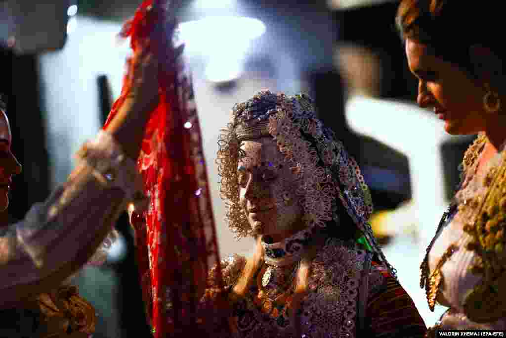 The exquisitely detailed decoration of the bride&#39;s face is finally unveiled during the wedding vows.