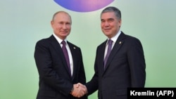 Russian President Vladimir Putin (left) meets with Turkmen President Gurbanguly Berdymukhammedov in Ashgabat on October 11.