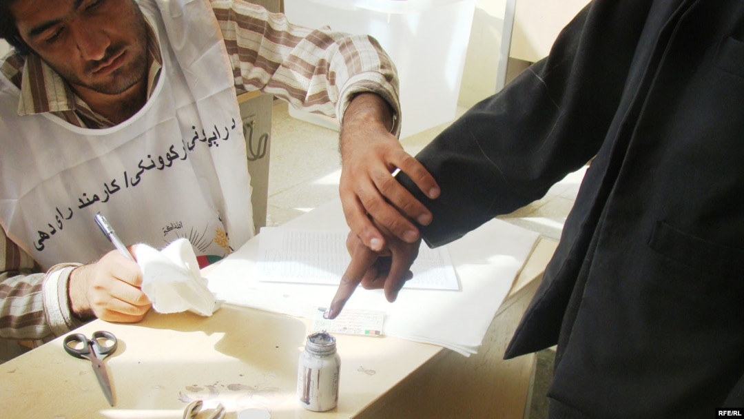 An Afghan man inks his finger while voting in the first round of the presidential election. Can he be convinced to vote again?