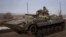 Ukrainian service members ride a BMP-1 infantry fighting vehicle near the frontline town of Bakhmut