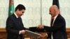 Afghan President Ashraf Ghani, right, exchanges documents with Turkmen President Gurbanguly Berdymukhammedov at the Presidential Palace in Kabul on August 27, 2015.