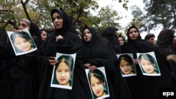 Protestors in Herat carry photos of killed victims and shout slogans against the killing of civilians from Hazara minority, who were allegedly slain by the Islamic State (IS) in November.