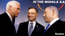 U.S. Vice President Mike Pence, Polish President Andrzej Duda and Israeli Prime Minister Benjamin Netanyahu talk during the family photo at the Middle East conference at the Royal Castle in Warsaw, Poland, February 13, 2019. 