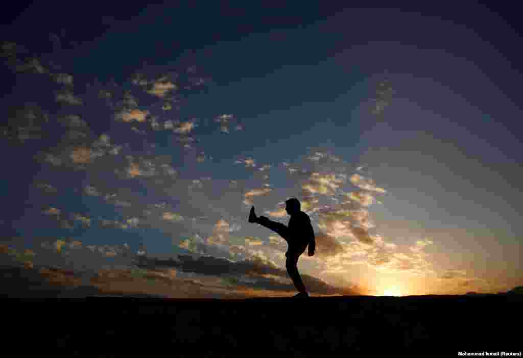 An Afghan man exercises in the early morning on a hilltop in Kabul. (Reuters/Mohammad Ismail)