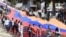 Nagorno-Karabakh - Schoolchidren carry a huge Karabakh Armenian flag during a public celebration in Stepanakert, 9May2016.