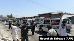 Ambulances transport the bodies of Afghan Sikhs killed in a suicide attack in Jalalabad on July 2.