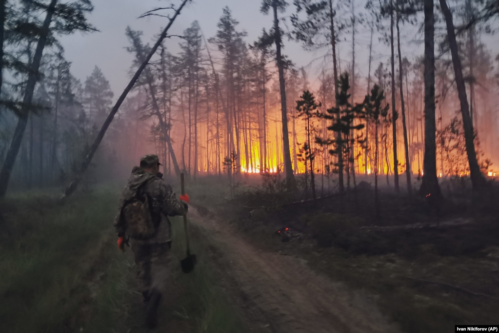 A volunteer heads off to fight a forest fire in Russia's Yakutia region on July 17. 