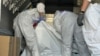 International Red Cross representatives check body bags containing the remains of soldiers during an exchange of the bodies of Russian and Ukrainian servicemen in Ukraine's Sumy region on August 2. 