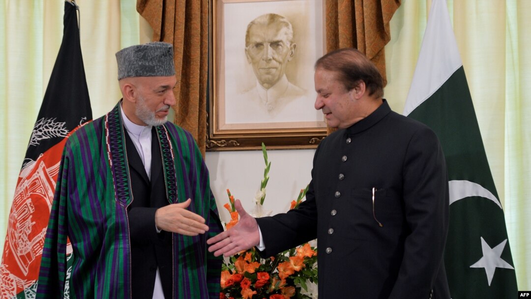 Pakistani Prime Minister Nawaz Sharif (right) greets Afghan President Hamid Karzai in Islamabad on August 26.