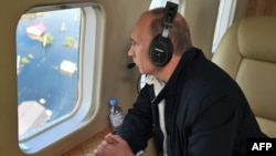 Russian President Vladimir Putin flies over the Far Eastern Amur region, which has been hit by severe flooding.