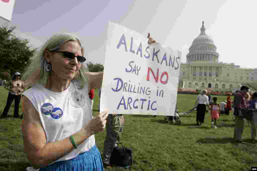 U.S. -- Carolyn Kremers of Fairbanks, Alaska, holds up a sign protesting oil drilling in Alaska's Arctic National Wildlife Refuge on the West Front of the US Capitol in Washington, DC, 20Sep2005