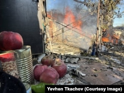 A house burns in the Donetsk region during one of Tkachov's rescue missions.
