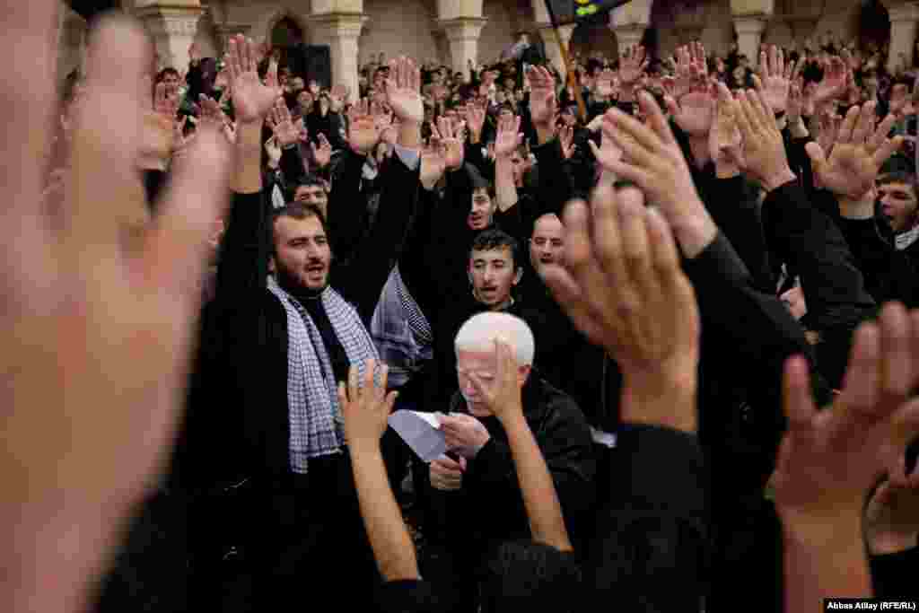 Məscidin həyətində sinə vuran insanlar