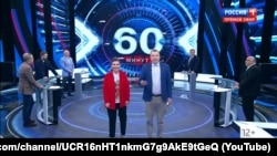 Ведущие программы «60 минут» Ольга Скабеева и Евгений Попов на российском государственном телеканале «Россия-1»