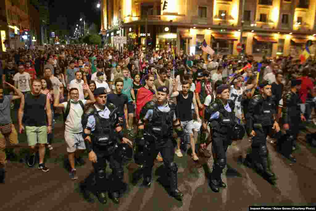 Protesters march through central Bucharest on August 12, the third consecutive night of antigovernment demonstrations in Romania.