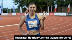 Sprinter Krystsina Tsimanouskaya flashes the victory sign during a track competition at a stadium in Szczecin, Poland, on August 15. 