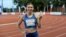 Sprinter Krystsina Tsimanouskaya flashes the victory sign during a track competition at a stadium in Szczecin, Poland, on August 15. 