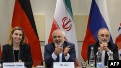 Switzerland -- (L-R) EU foreign policy chief Federica Mogherini, Iranian Foreign Minister Mohammad Javad Zarif and Head of Iran Atomic Energy Organization Ali Akbar Salehi wait for the opening of a plenary session on Iran nuclear talks in 2015.