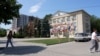 Moldova, People walk down the street with the Gagauzia People's Assembly building in the background, Comrat, July 29, 2026