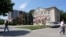 Moldova, People walk down the street with the Gagauzia People's Assembly building in the background, Comrat, July 29, 2026