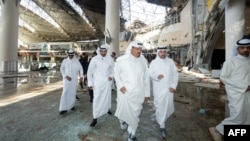 Kuwaiti officials inspect damage at the international airport after an Iranian attack on June 3.