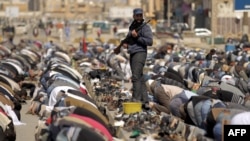 Rebel guards perform Friday Prayers in Benghazi. 