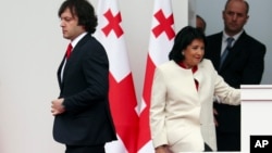 Georgia's Prime Minister Irakli Kobakhidze (left), and its president, Salome Zurabishvili (right), continue to battle over the legitimacy of the Law On Transparency Of Foreign Influence. (file photo)