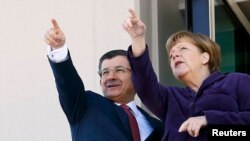 Turkish Prime Minister Ahmet Davutoglu (left) and German Chancellor Angela Merkel in Ankara on February 8