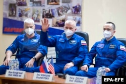 ISS crew members astronaut Mark Vande Hei of NASA and cosmonauts Oleg Novitskiy and Pyotr Dubrov of Roskosmos hold a press conference at the Baikonur Cosmodrome in Kazakhstan on April 8.