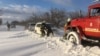 Rescuers help drivers trapped in the Mykolayiv region following heavy snowfall on November 27.