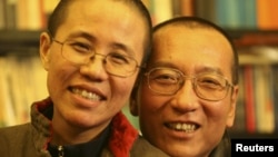 Chinese dissident Liu Xiaobo (right) and his wife Liu Xia pose in a photo released by his family.