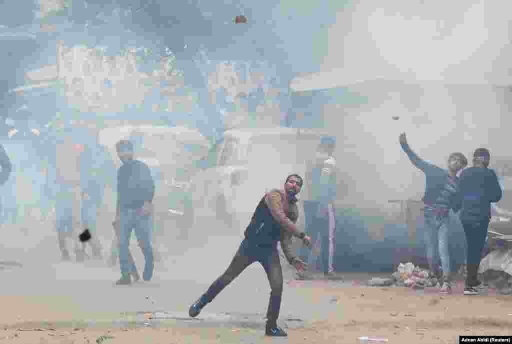 Demonstrators throw stones toward police in Seelampur on December 17.