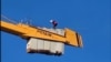 Tajik migrant on crane 