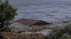 The roof of a house is seen in the Dnieper River, which flooded after Ukraine's Nova Kakhovka dam was breached on June 6.