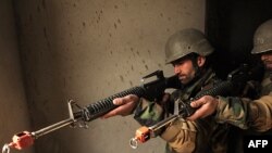 Afghan soldiers, armed with U.S.-made M16 rifles, take part in combat training on the outskirts of Kabul in late December.