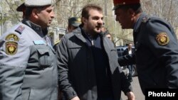 Armenia - Civic activist Argishti Kivirian is confronted by riot police during a demonstration in Yerevan, 4Apr2014.