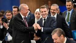 Turkish President Recep Tayyip Erdogan (left) speaks with French President Emmanuel Macron at a plenary session during the European Political Community (EPC) summit in Budapest on November 7. 2024.