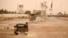 Pakistani security officials patrol the Pakistani side of the border with Afghanistan at Chaman on July 17 after it was closed following clashes between Afghan security forces and Taliban militants. 