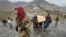 People carry the coffins of victims who died in what the Taliban government said was a Pakistani air strike on a drug rehabilitation center, during a mass burial in Kabul on March 18. 