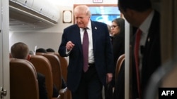 US President Donald Trump speaks to reporters aboard Air Force One on January 11.