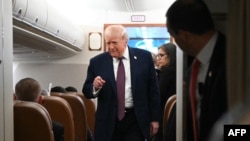 Donald Trump venind să le vorbească jurnaliștilor la bordul avionului prezidențial Air Force One, pe 11 ianuarie 2026
