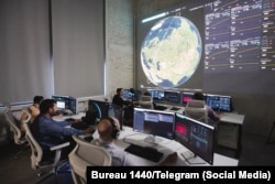 Engineers and flight controllers monitor Rassvet satellite telemetry, orbital paths, and network data.