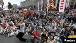 Soccer fans react as they watch the soccer match between the Netherlands and Denmark in the fan zone in Kyiv 