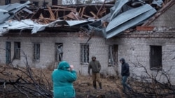 Residents inspect the site of a Russian Oreshnik missile strike in Dnipro on November 21. 