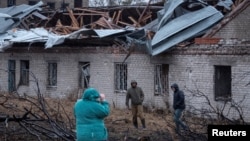 Residents inspect the site of a Russian Oreshnik missile strike in Dnipro on November 21. 