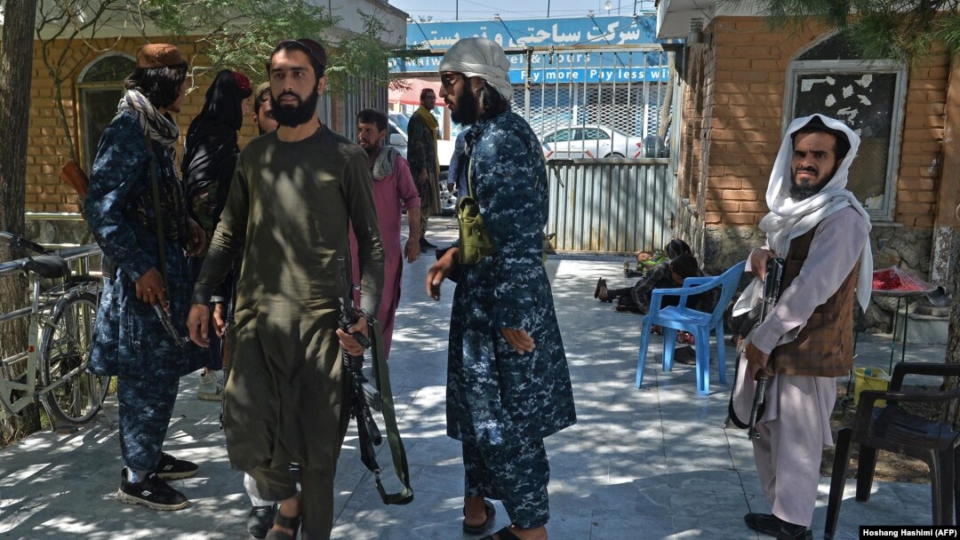Taliban fighters stand guard at the entrance of the Wazir Akbar Khan mosque in Kabul on September 17.