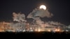 A full moon rises over Gazprom Neft's oil refinery in Omsk (file photo)
