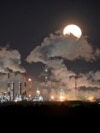 A full moon rises over Gazprom Neft's oil refinery in Omsk (file photo)