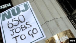 A protester holds up a placard during a rally in front of BBC's Bush House in London on January 26.